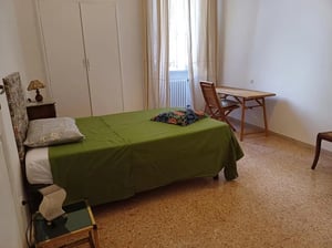 Bed nightstand desk and chair bedroom at Large room with french bed in Perugia Student Accommodation