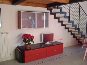 Red media console television stairs living area at Entire Apartment In Perugia Historic Centre in Perugia Student Accommodation