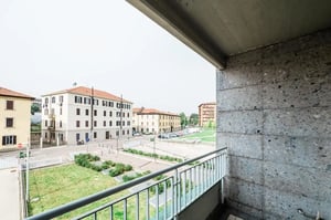 Balcony view buildings cars grass exterior at Bed in a homely twin bedroom, in Canovine in Bergamo Student Accommodation