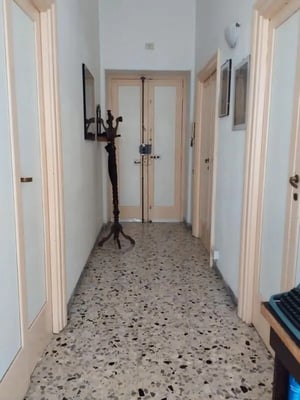 Hallway with doors coat rack and tiled floor hallway at Cozy twin bedroom in Viterbo in Viterbo Student Accommodation