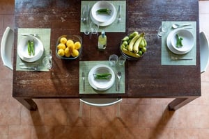 Table with place settings lemons bananas and peppers dining area at Splendid lofted studio in Pisa in Pisa Student Accommodation