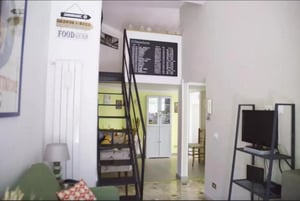 Departures board stairs television living area at Pleasant 2-bedroom apartment in Trastevere in Rome Student Accommodation