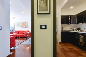 Red sofa kitchen area living room at Very Quiet Over Trastevere With Private Parking in Rome Student Accommodation