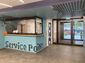 Service point desk with glass partition and doors. at Welcoming studio in Fennpfuhl in Berlin Student Accommodation