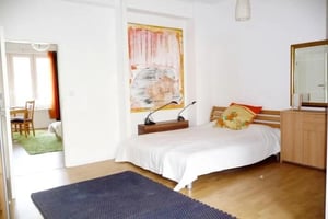Bed with pillows artwork and wooden dresser bedroom at Inviting 1-bedroom flat in Grunewald in Berlin Student Accommodation