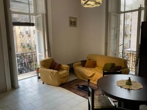 Yellow armchairs sofa rug table chair living room at Bed in shared bedroom in Naples City centre in Naples Student Accommodation