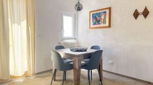 Table with four chairs and basket dining area at Appealing 1-bedroom apartment in the centre of Monopoli in Monopoli Student Accommodation