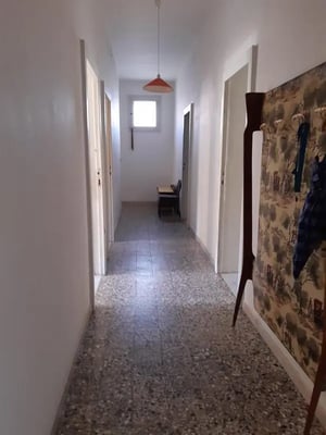Hallway with orange lamp and patterned wall hallway at Single Room With Private Balcony In Sassari Centre 5 Min Walk From Piazza D'Italia in Sassari Student Accommodation