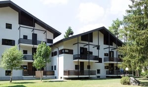 White apartment buildings with balconies exterior at Bright 2-bedroom apartment near Bagni di Bormio in Valdidentro Student Accommodation