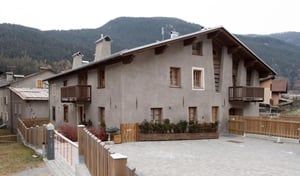 Stone building with balconies wooden fences exterior at Bright and cosy 1-Bedroom apartment close to Bormio in Valdidentro Student Accommodation