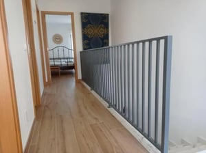 Hallway with doors railing artwork and bedroom hallway at Welcoming 3-bedroom house in Lagos in Lagos Student Accommodation