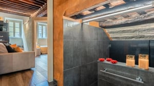 Tiled shower and sink with candles bathroom at Superb 1-bedroom apartment in the centre of Lucca in Lucca Student Accommodation