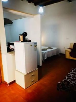 White refrigerator with coffee maker and bed bedroom at Cozy studio in the Kalsa area in Palermo Student Accommodation