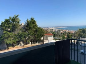 Balcony overlooking town and sea exterior at Cosy 2-bedroom apartment with a balcony, near Fonte das Pombas beach in Figueira Da Foz Student Accommodation