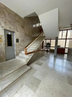 Marble staircase and elevator lobby interior shot at Cool 2-Bedroom Apartment in Turin in Turin Student Accommodation