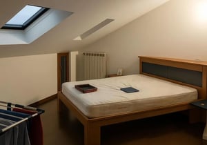 Bed laundry rack skylight radiator bedroom at Single Bedroom in Turin in Turin Student Accommodation