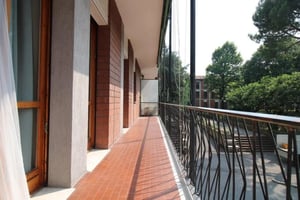 Balcony with tiled floor black railing and windows exterior at Neat single bedroom near the Mompiano metro in Brescia Student Accommodation