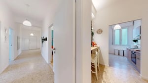 Hallway with doors and kitchen area at Colourful single bedroom near Facoltà di Medicina e Chirurgia in Brescia Student Accommodation