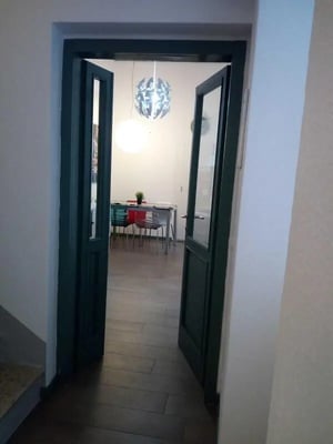Open doors to dining table and chairs dining area at Lovely single bedroom near Vittoria station in Brescia Student Accommodation