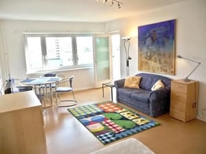 Sofa rug table chairs cabinet living room at Neat 2-bedroom flat in Schöneberg in Berlin Student Accommodation