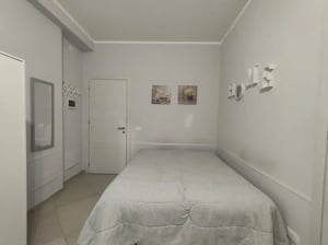 Bed with grey quilt and wall art bedroom at Comfortable and bright Studio next to Stazione Centrale di Palermo in Palermo Student Accommodation