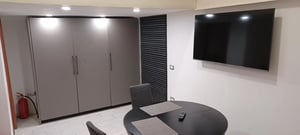 Wardrobe table chairs television fire extinguisher dining area at Studio in Central Naples in Naples Student Accommodation