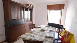 Wood hutch table with place settings dining room at Homely double bedroom near the Orti di San Pietro park in Sassari Student Accommodation