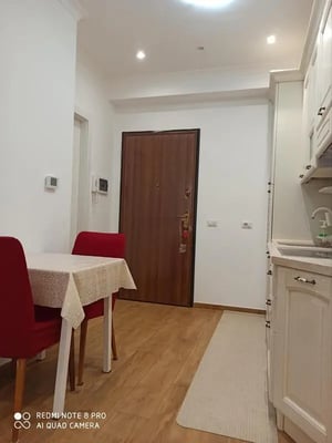 Dining table with red chairs kitchen counter exterior at Studio in Rome in Rome Student Accommodation