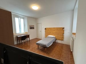 Bed desk and wardrobe bedroom interior at Minimalist one-bedroom apartment in the center of Bergamo: quiet, bright, and with utilities included in Bergamo Student Accommodation