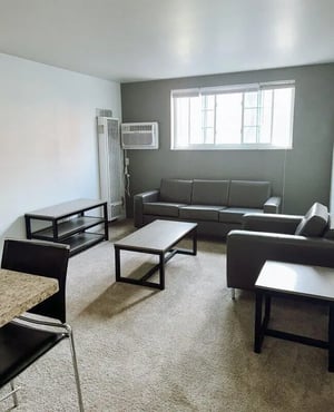 Sofa armchairs coffee tables and shelf living room at University Village in Laredo Student Accommodation