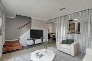 Sofa and TV in living room with dining area visible Living room at Across The Street Apartments in Denton Student Accommodation