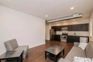 Sofa coffee table kitchen with appliances living room at Cooper Village in Camden Student Accommodation