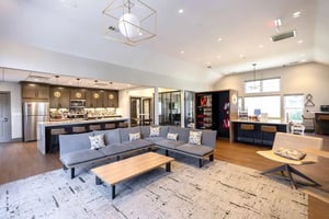 Sofa kitchen island bar stools coffee table living room at Collegiate Suites in Blacksburg Student Accommodation