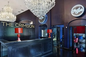Lobby desk chandeliers neon signs coffee bar entrance lobby at Crimson in Tuscaloosa Student Accommodation