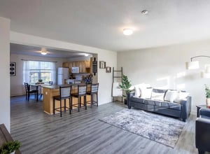 Living area kitchen with sofa and dining table living room at Copper Beech at Ames Apartments in Ames Student Accommodation