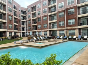 Apartment complex courtyard with swimming pool and lounge chairs exterior at Grandmarc at The Corner in Charlottesville Student Accommodation