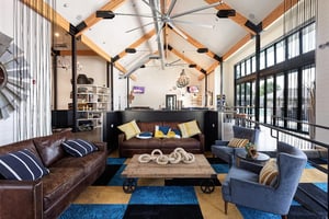 Leather sofas wood coffee table blue chairs living room at University Trails Apartments in Ann Arbor Student Accommodation