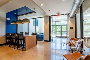 Wooden island with bar stools and lighting communal area at The Edition on Rosemary in Chapel Hill Student Accommodation