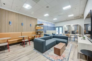 Modern lounge with sectional sofa and booths living room at University Village Towers in Riverside Student Accommodation