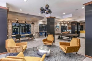 Chairs pool table and art living room at Aero on 24th in Gainesville Student Accommodation