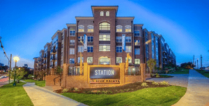 Modern brick apartment building exterior with signage exterior at Station at Five Points in Columbia Student Accommodation
