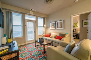 Cream sofas coffee table patterned rug living room at The Avenue Indianapolis in Indianapolis Student Accommodation