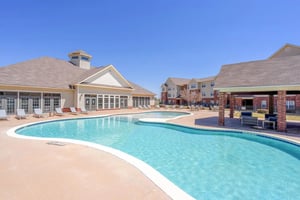 Pool lounge chairs buildings covered seating area exterior at The Grove at Lubbock in Lubbock Student Accommodation