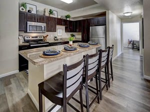 Kitchen island with bar stools and appliances kitchen at Campus Edge on UTA Boulevard in Arlington Student Accommodation