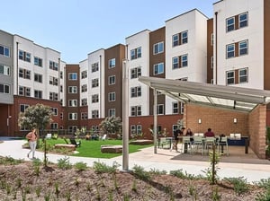 Apartment buildings with patio tables and grills exterior at Plaza Verde in Irvine Student Accommodation