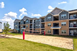 Volleyball court with apartments exterior at Stadium View in Jonesboro Student Accommodation