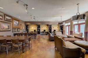 Large table chairs study desks and lounge seating living room at The Grove Apartments Cheney in Cheney Student Accommodation