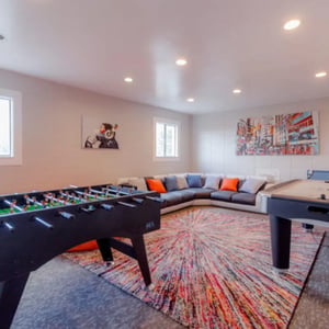 Foosball table sectional sofa colorful rug playing area at Campus Way in Provo Student Accommodation