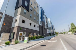 Modern multi-story building with leasing sign exterior at CollegePlace Provo in Provo Student Accommodation