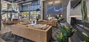 Leather sofas, modern art, plants, fireplace, lobby at The Vista in Turlock Student Accommodation